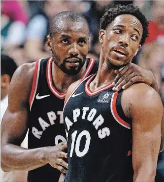  ?? TORONTO STAR FILE PHOTO ?? Toronto Raptors forward Serge Ibaka, left, chats with teammate DeMar DeRozan in a recent NBA contest. Ibaka has put together his best five games in a couple of months over the past two weeks.