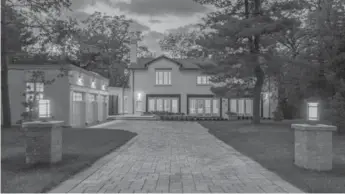  ??  ?? Built on the side of a hill and on the edge of a ravine, the house features a wide interlocki­ng brick drive.