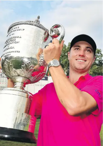  ?? STUART FRANKLIN/GETTY IMAGES ?? American Justin Thomas lifted the Wanamaker Trophy with pride after winning the 2017 PGA Championsh­ip by two strokes Sunday at Quail Hollow in Charlotte, N.C. to claim his first major title.