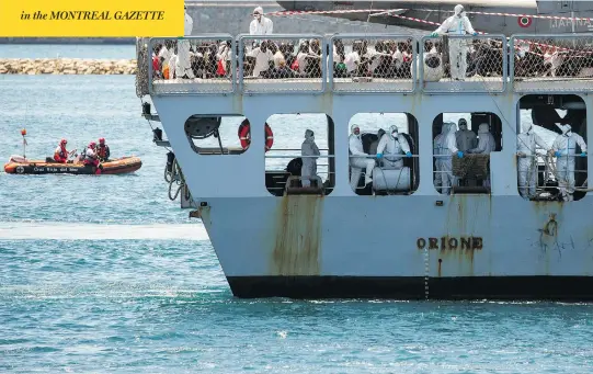  ?? PABLO BLAZQUEZ DOMINGUEZ / GETTY IMAGES ?? Italian navy vessel Orione arrives carrying migrants Sunday at Spain’s port of Valencia, the third of three rescue ships to dock at the port that day.