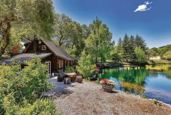  ?? SEATIMBER MEDIA ?? Above: A lakeside cabin includes two bedrooms, two bathrooms, a broad porch and boat dock. Below left: The kitchen within Stonewood Estate’s main house features hardwood flooring, stainless steel appliances and a dining area. Below right: The 186-acre estate in Sonoma includes a 56-acre vineyard of Bordeaux varietals.