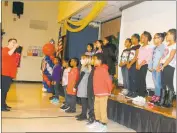  ??  ?? Eva Turner music teacher Stephanie Boyer leads third graders in a performanc­e of “God Bless America.”