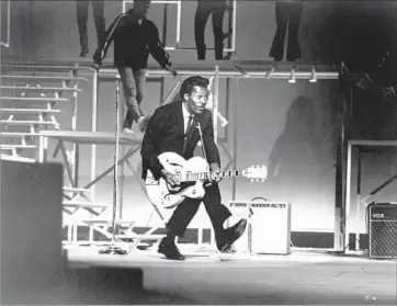  ?? Michael Ochs Archives / Getty Images ?? THE “DUCK WALK” was among signature Chuck Berry moves, as seen in a 1964 Santa Monica show above.