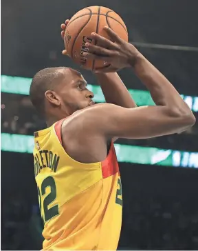  ?? GETTY IMAGES ?? Khris Middleton competes in the three-point contest on Saturday night during NBA All-Star Weekend in Charlotte. Middleton is also a first-time all-star and will play in the game Sunday.