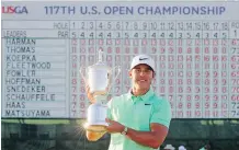  ?? JAMIE SQUIRE/ GETTY IMAGES FILE ?? American Brooks Koepka holds up the championsh­ip trophy after winning the U.S. Open at Erin Hills in Erin, Wis.