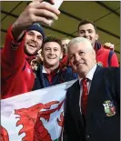  ??  ?? SNAP JUDGMENT: Gatland poses as Lions fans take selfies during the game