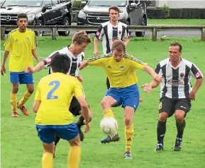  ?? SUPPLIED ?? Brad West, left, and Scott Parsonage surround their Rotorua United opponent as Comag Matamata Swifts helped themselves to a 3-1 win on Saturday.