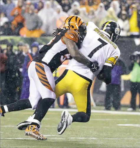  ?? John Minchillo/Associated Press ?? Cincinnati Bengals linebacker Vontaze Burfict hits quarterbac­k Ben Roethlisbe­rger in a playoff game Jan. 9. The Bengals want Burfict to alter his tackling style.