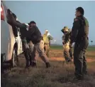  ?? COURTNEY SACCO/CALLER-TIMES ?? A migrant is searched last week before being transporte­d by Border Patrol near Mission, Texas.