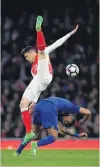  ?? PHOTO: GETTY IMAGES ?? Gabriel, of Arsenal, falls over Leonardo Ulloa, of Leicester City, during an English Premier League match at the Emirates Stadium in London yesterday. Arsenal won 10.