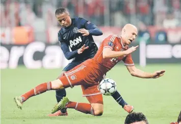  ??  ?? Manchester United’s Patrice Evra (left) vies with Bayern Munich’s Arjen Robben during the UEFA Champions League quarter-final second leg match in Munich, southern Germany.