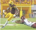  ?? PATRICK BREEN/AZCENTRAL SPORTS ?? ASU's Kalen Ballage (7) hurdles a tackle from New Mexico State's Jacob Nwangwa during the third quarter at Sun Devil Stadium on Aug. 31.