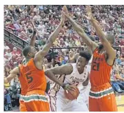  ?? STEVEN CANNON/AP ?? UM’s Davon Reed, left, and Kamari Murphy, (21), really stepped up as team leaders late in the season after the Hurricanes lost several players to injury.