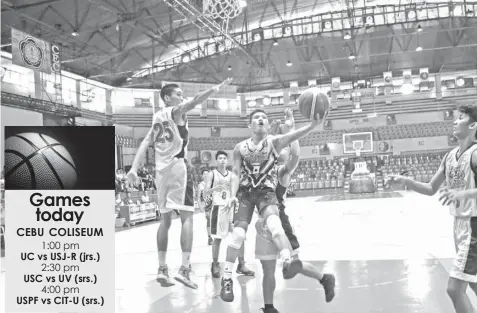  ??  ?? Kyle Ochavo of USPF goes up for a twinner during their CESAFI Partner's Cup game against CIT-U yesterday at the Cebu Coliseum. USPF won by a mile, 83-41.