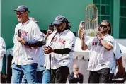  ?? Michael Dwyer/Associated Press ?? Members of the 2004 Boston Red Sox World Series championsh­ip team Johnny Damon, right, Manny Ramirez, center, and Mike Timlin take the field during ceremonies before an opening day baseball game at Fenway Park against the Baltimore Orioles on Tuesday, April 9, in Boston.