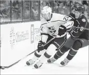  ?? Jay LaPrete Associated Press ?? TREVOR LEWIS of the Kings gets the puck ahead of Zach Werenski of Columbus in the first period.