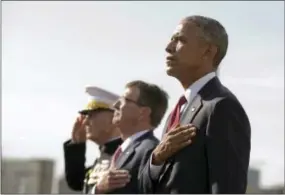  ?? THE ASSOCIATED PRESS ?? President Barack Obama, right, with Defense Secretary Ash Carter, center, and Chairman of the Joint Chiefs of Staff Gen. Joseph Dunford, stand at attention as the national anthem is played during a memorial ceremony at the Pentagon in Washington on...