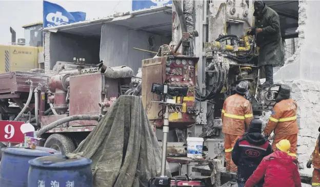  ??  ?? 0 Members of a rescue team working at the site of a gold mine explosion where 22 miners are trapped undergroun­d in Qixia, in eastern China’s Shandong province