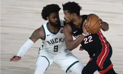  ??  ?? Miami Heat forward Jimmy Butler (22) drives against Milwaukee Bucks guard Wesley Matthews (9) during the second half of Tuesday’s Game 5. Photograph: Kim Klement/USA Today Sports