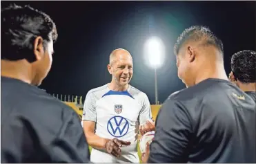  ?? USA Today Sports - Danielle Parhizkara­n ?? U.S. national team coach Gregg Berhalter signs soccer balls for migrant workers during a community event this past week at Al Gharrafa Stadium ahead of the World Cup in Qatar
