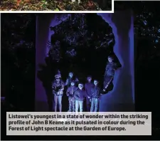  ??  ?? Listowel’s youngest in a state of wonder within the striking profile of John B Keane as it pulsated in colour during the Forest of Light spectacle at the Garden of Europe.