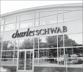  ?? Elise Amendola Associated Press ?? UNDER THE DEAL, Charles Schwab would see its business add 12 million client accounts and $1.3 trillion in assets. Above, a Schwab branch in Burlington, Mass.