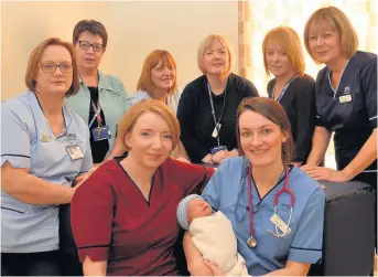 ??  ?? Born to succeed Members of the award-winning maternity team with baby Hunter Ness