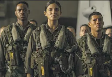  ?? Photograph­s by Scott Garfield Paramount Pictures ?? PILOTS in training are played by Jay Ellis, left, Monica Barbaro and Danny Ramirez in “Top Gun: Maverick.”