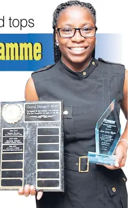  ??  ?? Ava-Gay Lindo, graduate of the Bethlehem Moravian College, with her trophies for the General Manager’s Exceptiona­l JN Youth Ambassador Award.