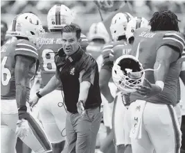  ?? AL DIAZ adiaz@miamiheral­d.com ?? Coach Manny Diaz tries to rally his players as they come off the field Saturday, but the Hurricanes found no remedy against top-ranked Alabama.