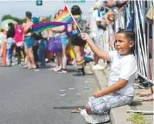  ?? Seth McConnell, Special to The Denver Post ?? Isaac Navarro, 8, waves a rainbow flag during Sunday’s Coors Light PrideFest Parade.