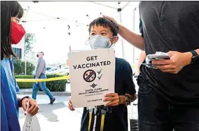  ?? NOAH BERGER / AP FILE ?? Matthew Yip, 8, waits in line to receive a Pfizer COVID-19 vaccine in San Jose Wednesday.