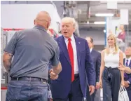  ?? ANDREW HARNIK/ASSOCIATED PRESS ?? President Donald Trump greets men learning how to machine parts as he tours Waukesha County Technical College in Pewaukee, Wis., on Tuesday.