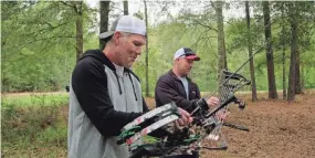  ?? COURTESY USA NETWORK ?? Brett Favre, left, and ‘Stone Cold’ Steve Austin shoot bow and arrow in Mississipp­i during an episode of “Straight Up.”