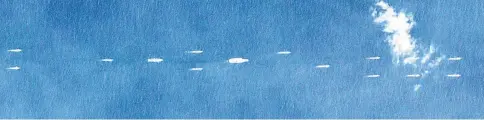  ??  ?? File picture by Planet Labs Inc shows China’s sole operationa­l aircraft carrier, the Liaoning (centre), sailing with other ships at sea, south of China’s southern Hainan island. — AFP photo