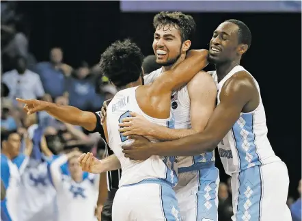  ?? MARK HUMPHREY/THE ASSOCIATED PRESS ?? North Carolina forward Luke Maye, center, celebrates with teammates after shooting the winning basket in the second half of the South Regional final game against Kentucky in the NCAA Tournament on Sunday in Memphis, Tenn. The basket gave North Carolina...
