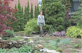  ??  ?? Lilith Fowler walks through the front garden. Participan­ts on the Eastside garden tour can visit the site July 25.