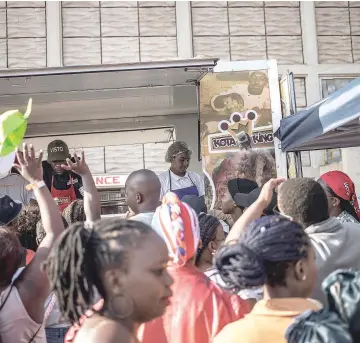  ??  ?? Hundreds of people attend the Kota Sandwich Festival on Sept 8 at Kliptown in Soweto, South Africa. Soweto’s best-known street food is the kota sandwich. “Kota” is an approximat­ion of the word “quarter,” for the quarter of the loaf of bread that is the base of the sandwich.