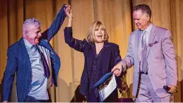  ?? Jana Asenbrenne­rova/Special to The Chronicle 2018 ?? Event producer Marc Huestis (left) and host Eddie Muller celebrate Novak (center) during a 2018 tribute at S.F.’s Castro Theatre.