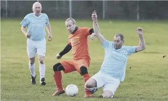  ??  ?? Tackling action from Seaton Buildings Over 40s’ game against Mill View Over 40s.