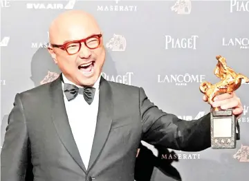  ??  ?? Xu Zheng holds his award for Best Leading Actor at the 55th Golden Horse Awards in Taipei last November. — Shuttersto­ck photo