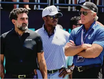  ?? Seth Wenig/Associated Press ?? Yasir Al-Rumayyan, left, governor of Saudi Arabia’s Public Investment Fund, Majed Al-Sorour, CEO of Golf Saudi, center, and Greg Norman, CEO of LIV Golf, watch at the first tee during the second round of the Bedminster Invitation­al in Bedminster, N.J., on July 30.