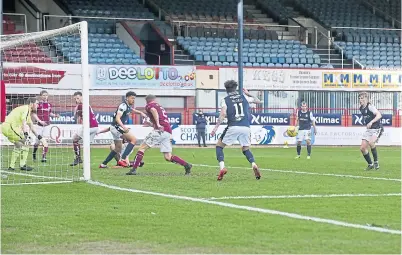  ??  ?? Max Anderson scores Dundee’s second goal against Arbroath on Saturday.