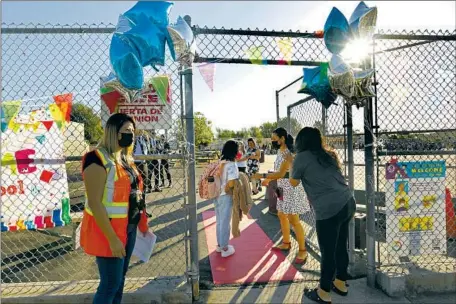  ?? PARENTS SAY Carolyn Cole Los Angeles Times ?? goodbye as they watch their children enter Vena Avenue Elementary in Arleta on the f irst day of classes in the Los Angeles Unified School District. Though cases of monkeypox in kids remain rare, infections among adults in L. A. County continue to rise.