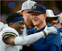  ?? AJ MAST/ASSOCIATED PRESS ?? Michigan coach Jim Harbaugh (right) is happy that he moved Mike Sainristil from wide receiver to defensive back.