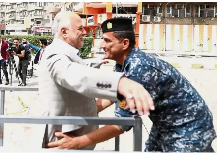  ??  ?? Off to vote: Abadi arriving at a polling station during the parliament­ary election in Baghdad.