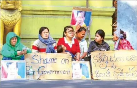  ?? HONG MENEA ?? Long Kimheang – with her child in her arms – sits with Rath Rott Mony’s supporters outside the Embassy of the Russian Federation in Phnom Penh for a fourth time on Wednesday.