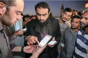  ?? Victor Besa for The National ?? Abu Muadh, centre, the Expo Live grant-winner for his Smart Labour smartphone app, wants to help workers improve their lives by teaching them English