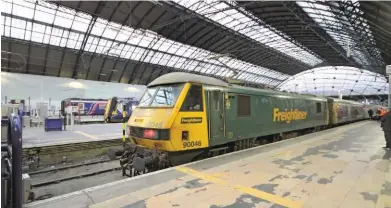  ?? DONALD CROALL. ?? Freightlin­er 90046 stands at Glasgow Queen Street on April 2, having hauled the 2139 London Euston-Glasgow Queen Street Sleeper, becoming the first AC electric locomotive to haul a public passenger train into the terminus.