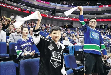  ?? — PHOTOS: GETTY IMAGES ?? Fans wave rally towels as they cheer during a pre-season game between the Los Angeles Kings and the Vancouver Canucks at the Mercedes-Benz Arena on Thursday in Shanghai.